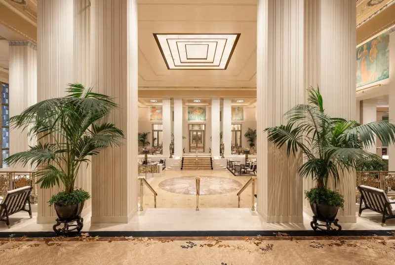 Grand Art Deco lobby with soaring columns at Waldorf Astoria New York.